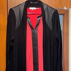 Large Calvin Kline orange sleeveless v neck blouse with black leather trim.